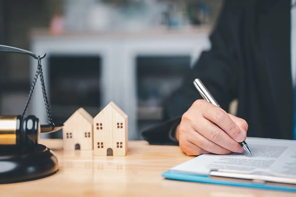 Attorney signing documents symbolizing asset division during a divorce